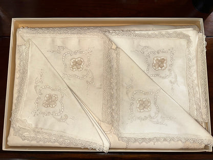 White embroidered linen napkins with lace trim