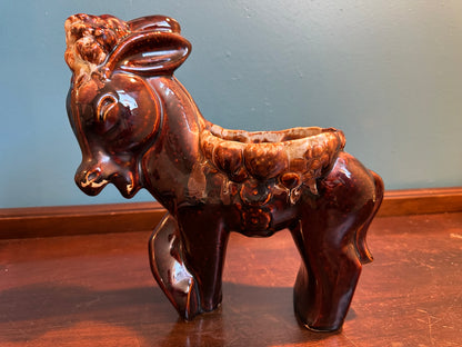Vintage ceramic McCoy style donkey planter with glossy brown drip glaze and decorative saddle
