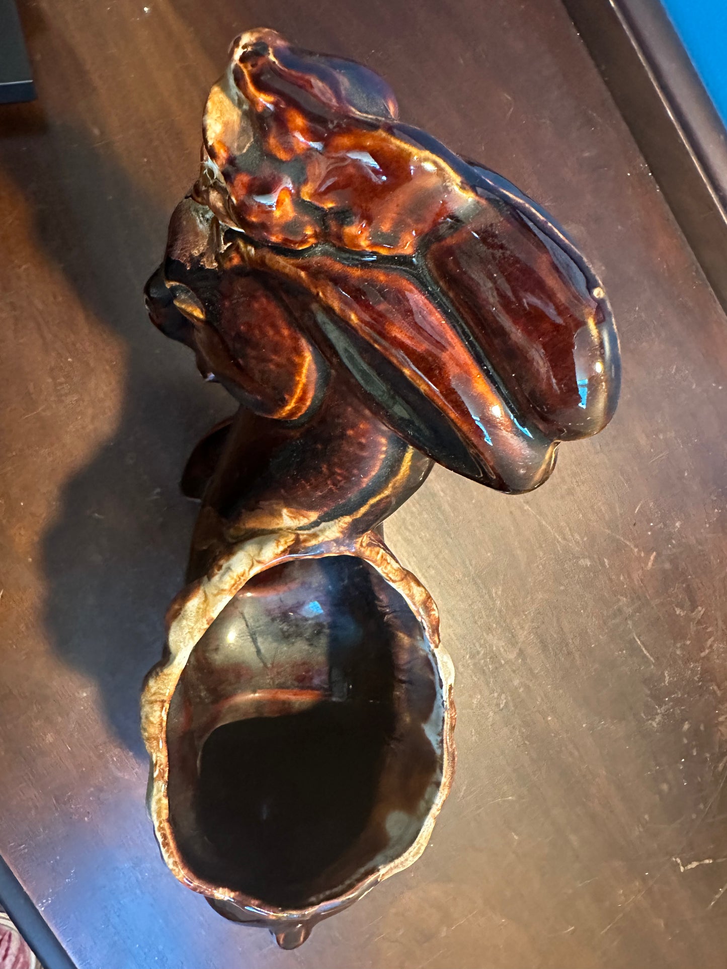 Top view of vintage USA pottery donkey planter with rich brown and caramel drip glaze