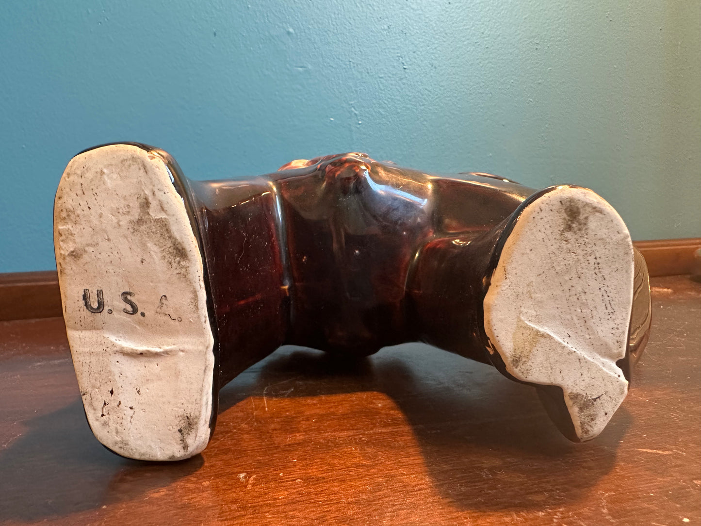 Underside of vintage ceramic donkey planter showing impressed U.S.A. pottery mark