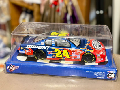 A die-cast model race car in its original blue display box with a clear plastic cover
