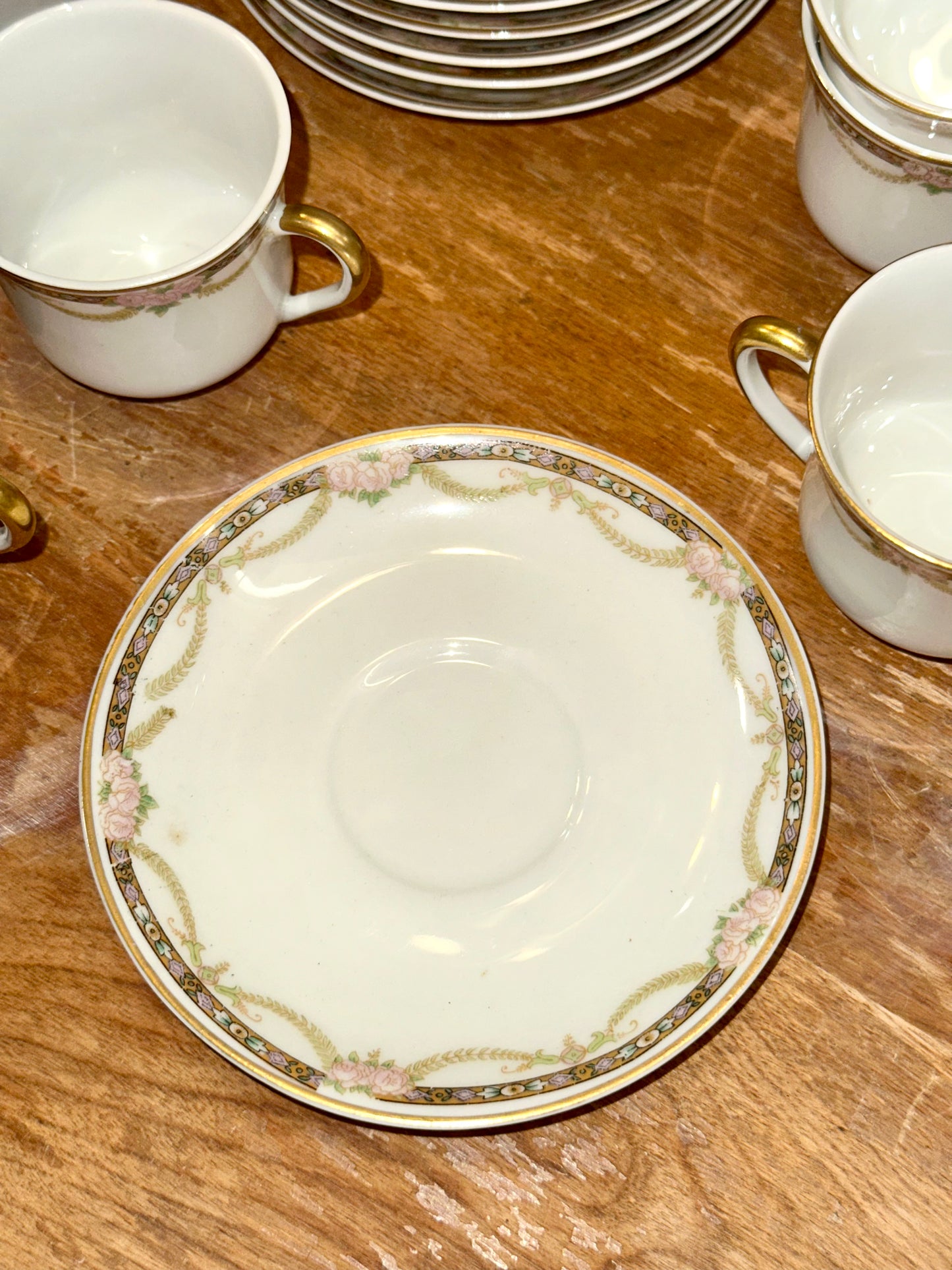 White porcelain saucer with pink floral border