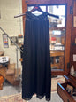 Full-length front view of the vintage Saks Fifth Avenue black evening gown featuring a sleeveless flowing chiffon silhouette and ornate black beaded neckline.