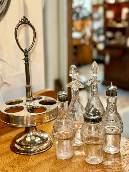 Vintage glass cruet and condiment set with decorative silver-tone stand