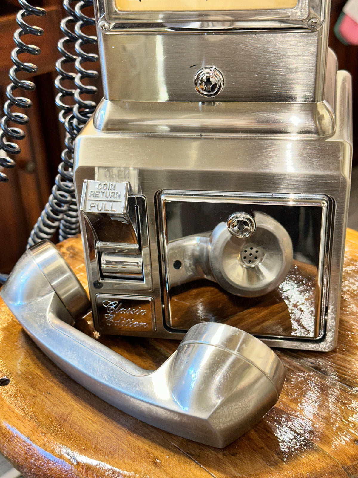 Vintage chrome payphone with classic rotary dial