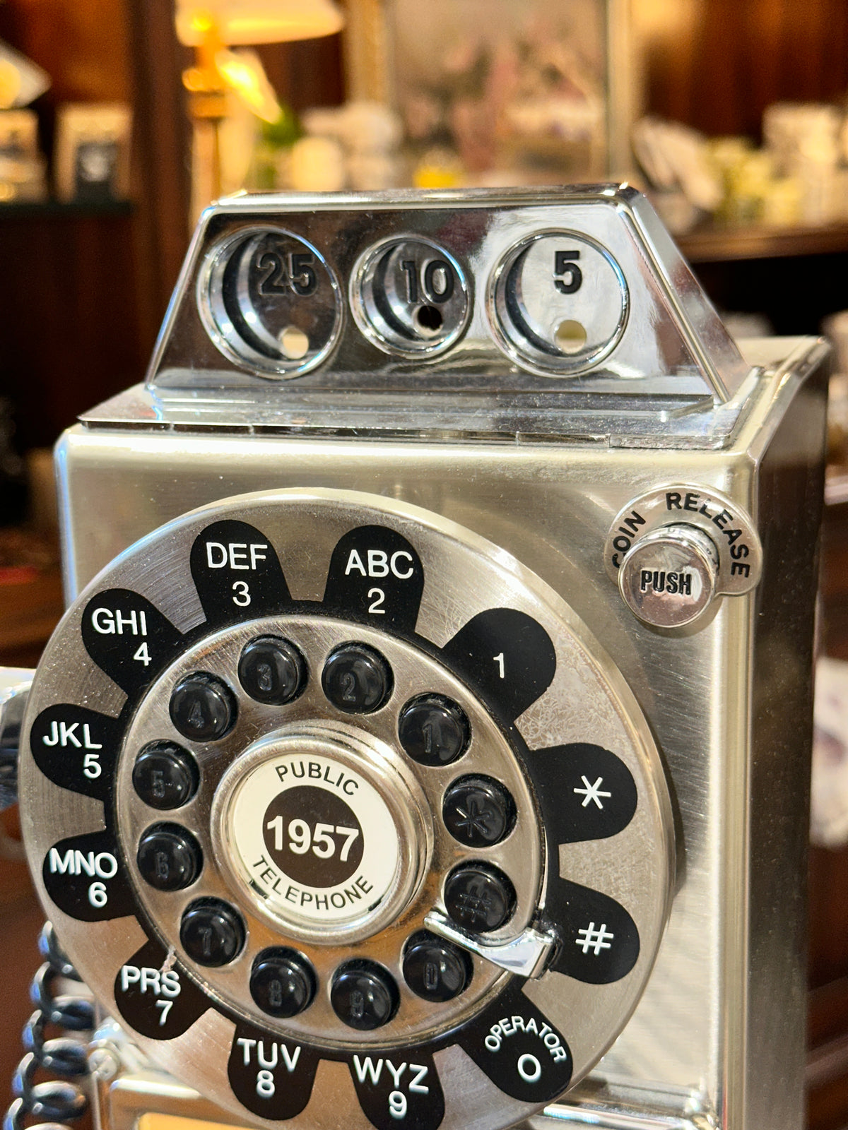 Vintage chrome rotary payphone handset and coin-operated telephone details