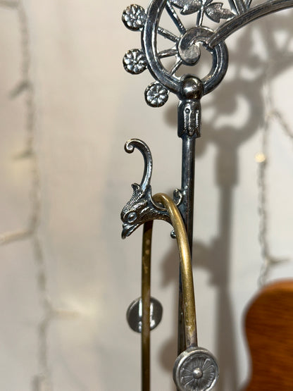 Detailed view of the ornate arched handle, decorative metal accents.
