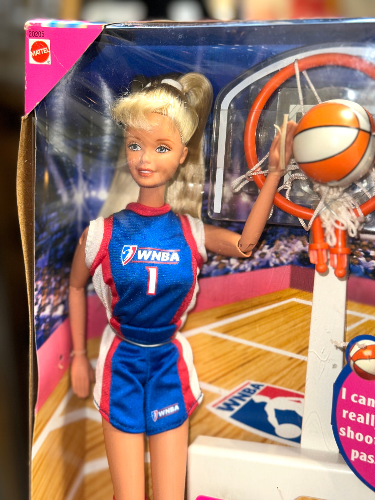 Side view of the original 1998 WNBA Barbie packaging showing basketball-themed graphics and product information.