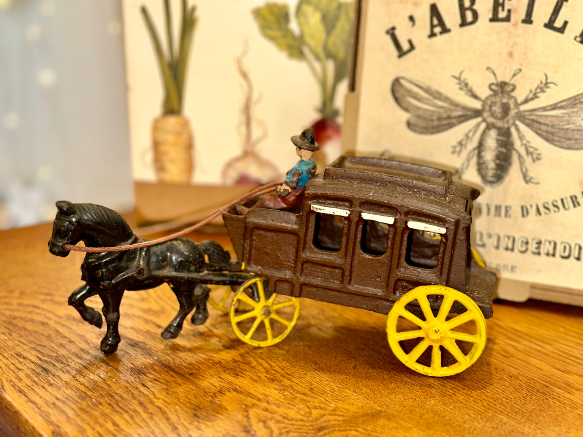 Front angled view of collectible cast iron stagecoach with horse
