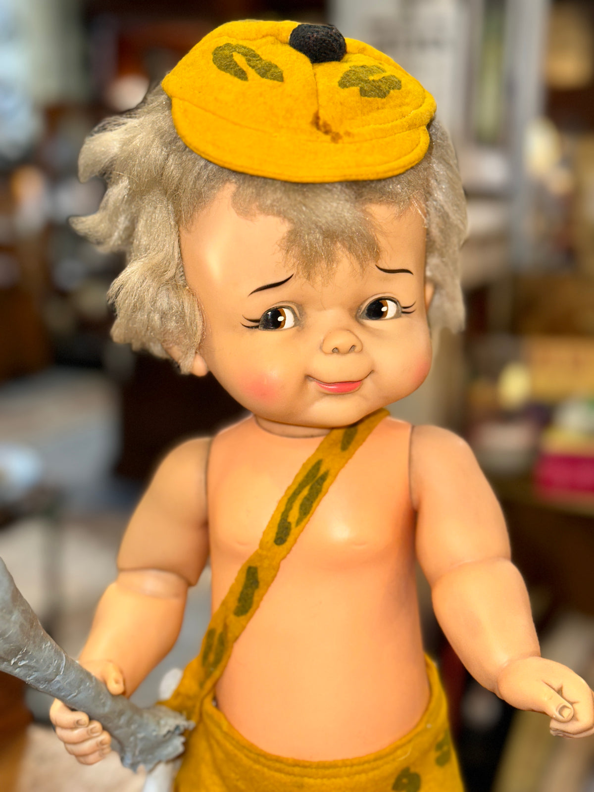 Close-up of vintage Bamm-Bamm Rubble doll face and blonde hair