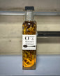 Orange rosemary vinegar bottle with fresh oranges and rosemary sprigs