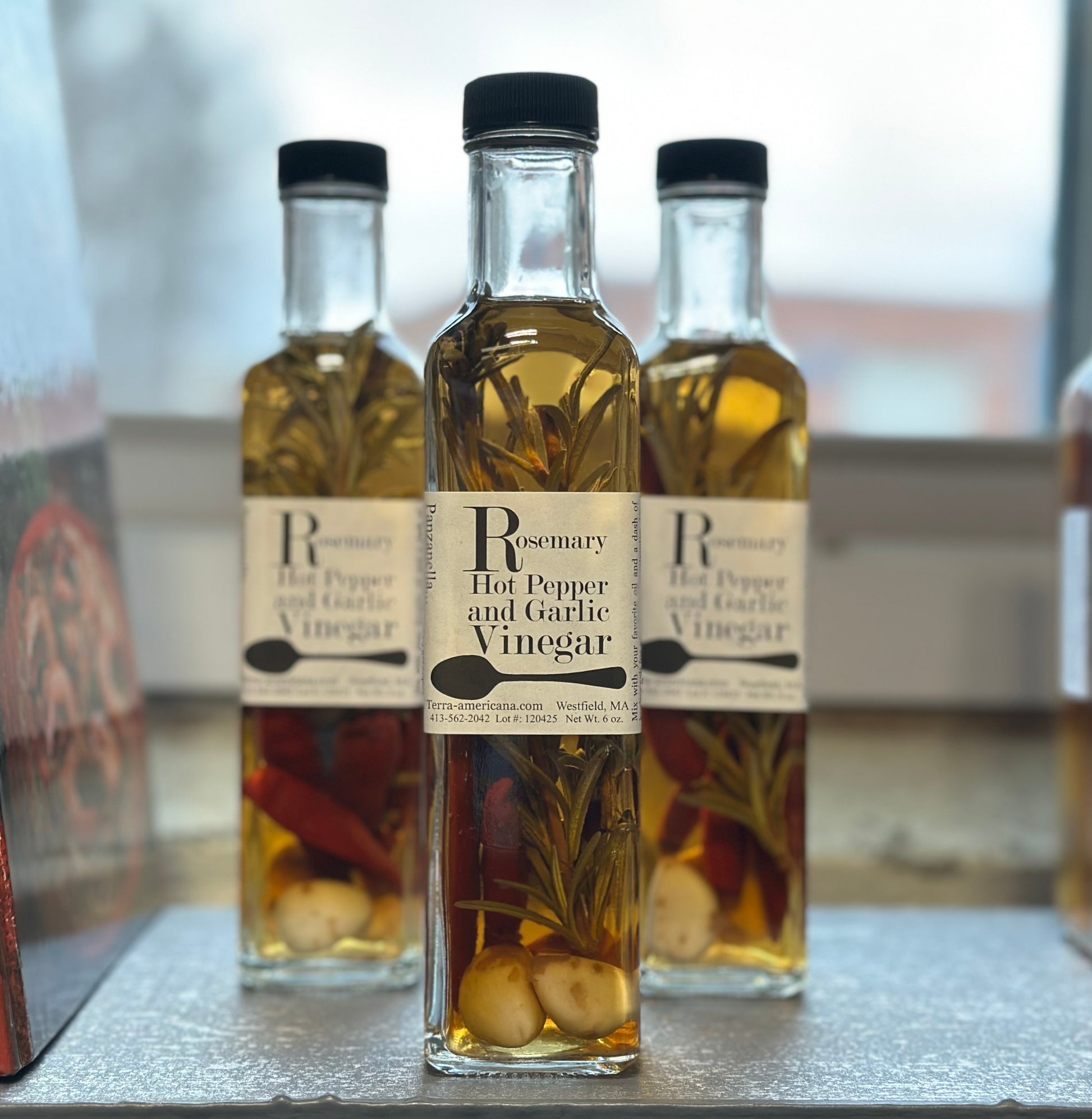Artisan rosemary hot pepper garlic vinegar with fresh herbs - gourmet spicy herbal vinegar