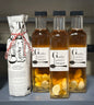Garlic lovers vinegar bottle with fresh whole garlic cloves and bulbs
