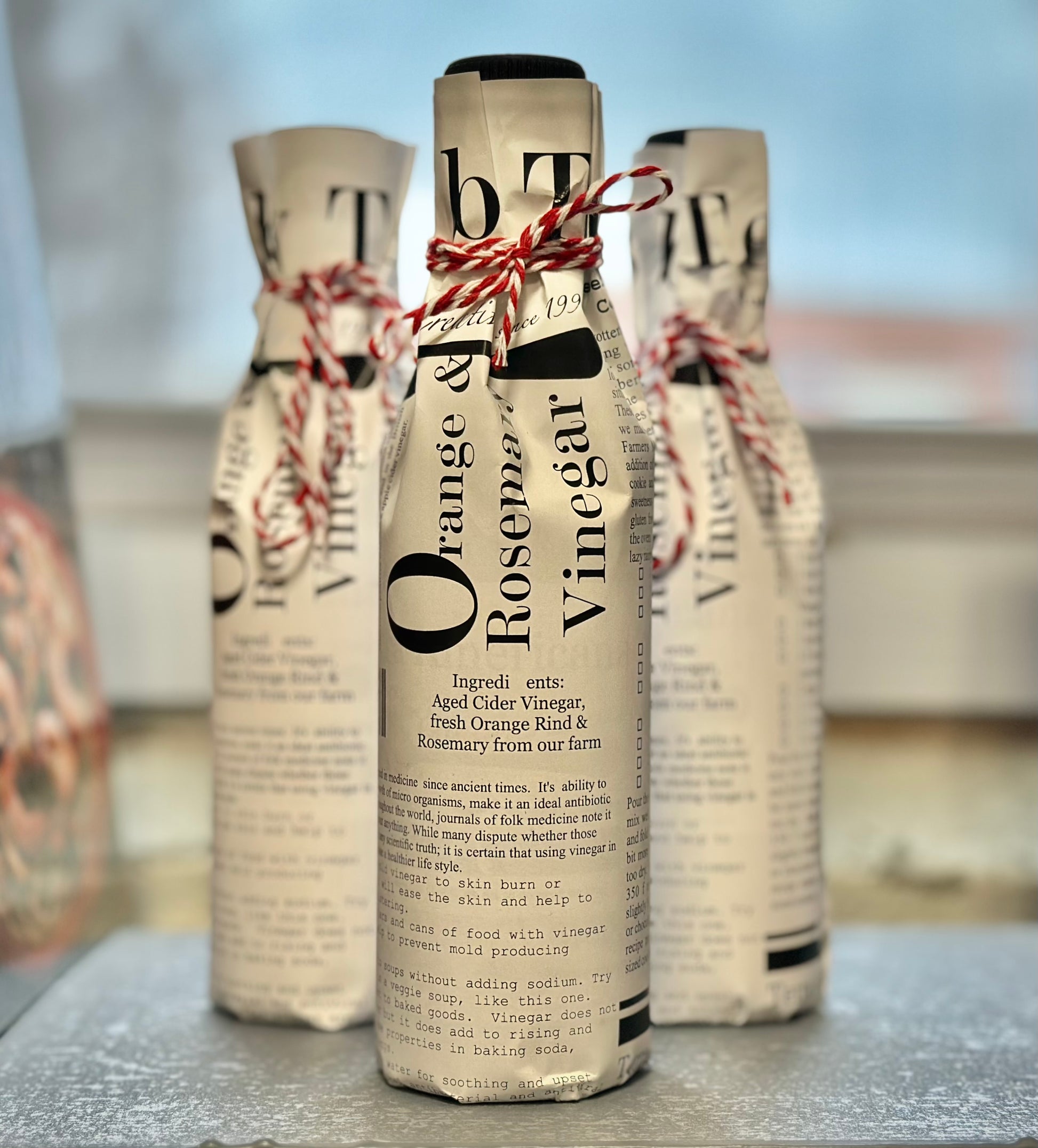 Gift-wrapped orange rosemary vinegar mini wine bottle - artisan herb citrus food gift