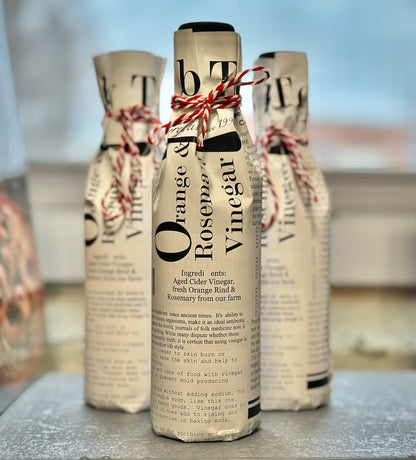 Gift-wrapped orange rosemary vinegar mini wine bottle - artisan herb citrus food gift