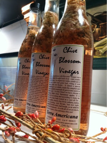Chive blossom vinegar with fresh chive flowers and spring herbs