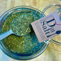 Dill Salt seasoning blend displayed in a glass jar with a metal scoop