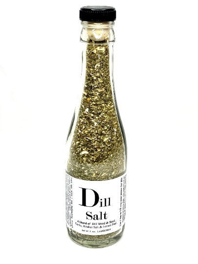 Dill Salt seasoning packaged in a labeled mini glass bottle contains a vibrant green blend of dill weed, dill seed, garlic, kosher salt, and lemon peel.